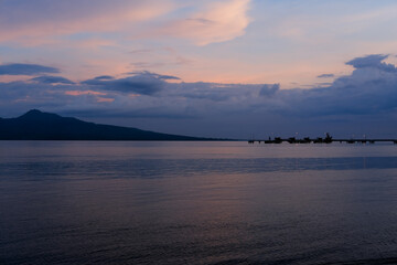 sunset on Dermaga Cinta Beach, Banyuwangi. Sunset with view of Bali Island. Sunset over the sea.