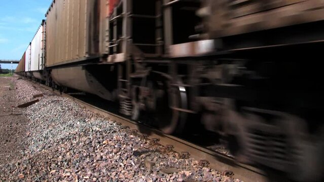 Close up shot of train wheels running along the near track.
