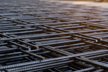 Group of new deformed bar or reinforced concrete construction steel net piles on outdoor ground. Selective focus and blurred for copy space.