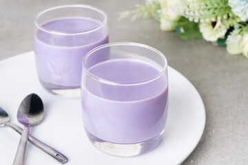 Homemade sweet taro silky pudding in a glasses cup and placed on a white plate. Healthy snacks...