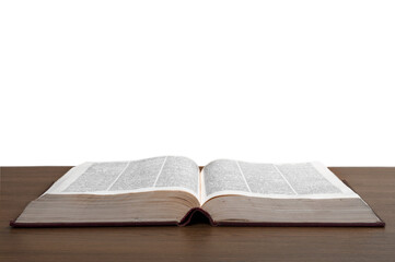Open old book on wooden desk