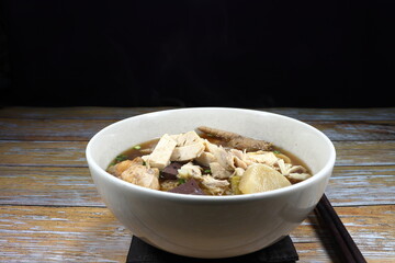 Soup of rice noodle and chicken meat serving in the bowl. Famous street food menu in Asia.