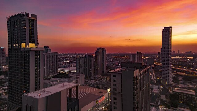 Timelapse view of colorful sunset of Bangkok, Thailand. View of cityscape with many skyscrapers during sunset 