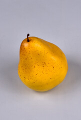 Artificial pear on a white background close-up