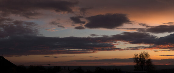 Landscape at sunset. Tragic gloomy sky. Panorama. Crimson twilight.