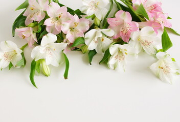 Flowers background top view template mockup with copy space. White and pink flowers frame on white ...