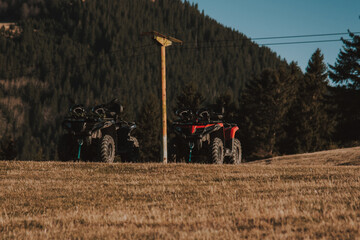 Beautiful nature landscape with ATV awd quadbike motorcycle and cloudscape sky background. Offroad adventure trip. Extreme sports activity. Front view. Concept motocross quadricycle background