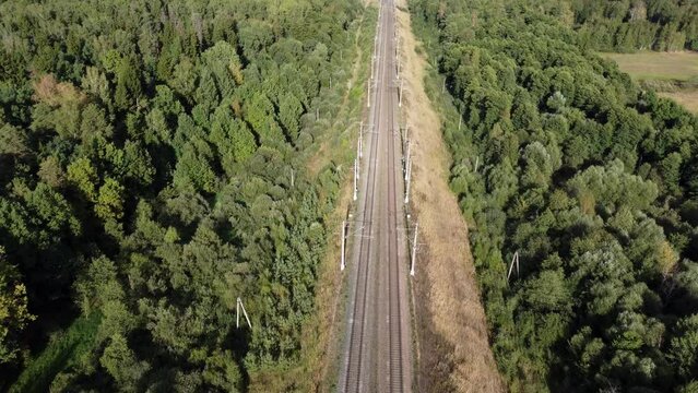 flight over an empty electrified railway in the forest