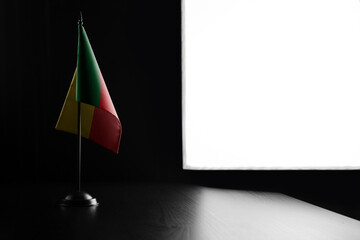 Small national flag of the Benin on a black background