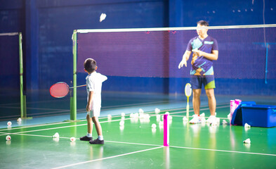 Boys training badminton indoor  activitiy