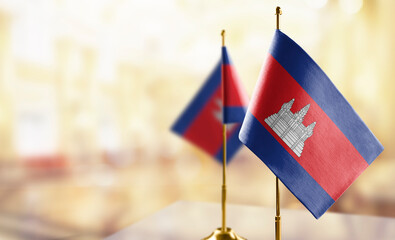 Small flags of the Cambodia on an abstract blurry background