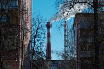 Smoking pipes of a thermal boiler house on a winter morning. Moscow region. Russia