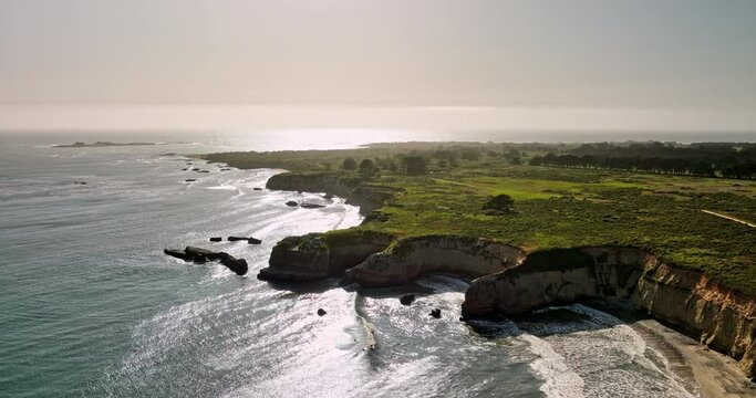 A&ntilde;o Nuevo State Park California Aerial v1 flyover cove beach capturing shimmering golden sunlight shinning on the sea water and oceanic rocky cliff landscape - Shot with Mavic 3 Cine - May 2022