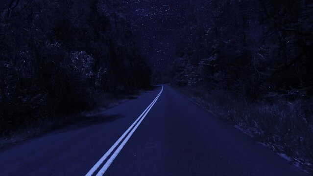 Rear facing night driving point of view POV for interior car scene green screen replacement - night footage under a clear starry sky, on quiet deserted country roads with a slight righthand bend