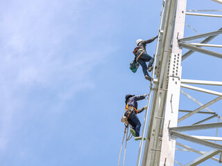 Lineman climbing on transmission line tower