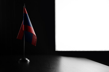 Small national flag of the Laos on a black background