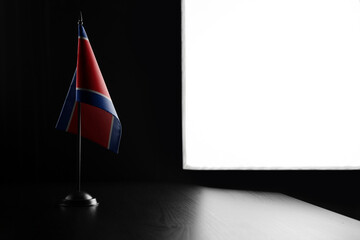 Small national flag of the North Korea on a black background