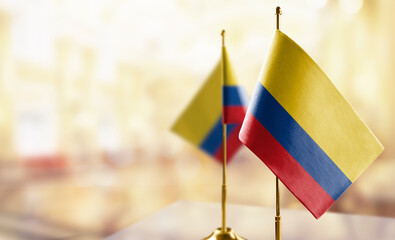 Small flags of the Colombia on an abstract blurry background