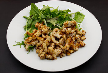 Straccetti beef with lettuce isolated on black background. View from above