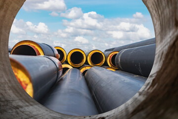 Insulated pipe. Large metal pipes with a plastic sheath at a construction site. Modern pipeline for...