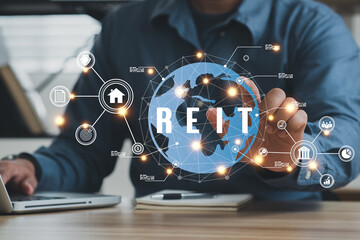 Businessmen using a computer to Real Estate Investment Trust REIT on double exsposure business background..