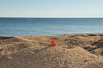 Small Wooden Christmas tree on the sandy beach. Selective focus on the tree. Issyk-Kul Lake. Kyrgyzstan. Holiday.