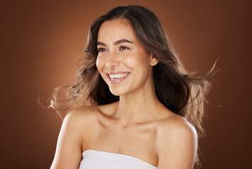 Hair, beauty and skincare with a model woman in studio on a brown background for natural or keratin...