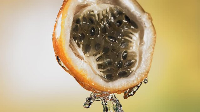 Slow Motion Macro Shot of Flowing Granadilla Juice from Halved Granadilla