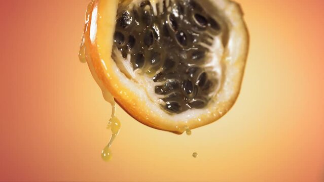 Slow Motion Macro Shot of Flowing Granadilla Juice from Halved Granadilla