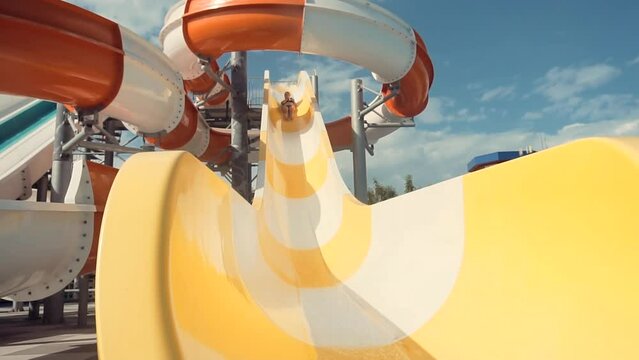 having fun on water slide . joyful sliding on waterpark water slide