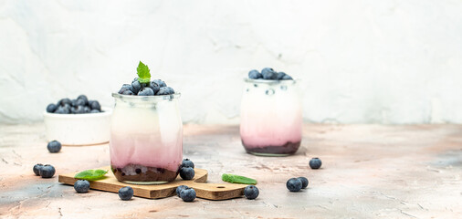 Obraz na płótnie Canvas parfait blueberries with yogurt and blueberry jam. Healthy breakfast. Super food healthy eating vegetarian vegan food on a dark background. Long banner format place for text