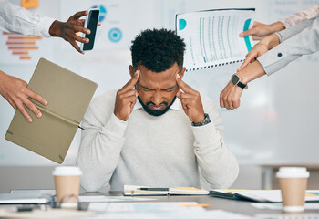 Stress, burnout and tired black man with headache, frustrated or overwhelmed by coworkers at workplace. Overworked, mental health and anxiety of exhausted male worker multitasking at desk in office. - obrazy, fototapety, plakaty