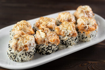 Sushi roll volcano. Sushi with scallop, avocado, cream cheese and sesame. Sushi menu. Japanese food.
