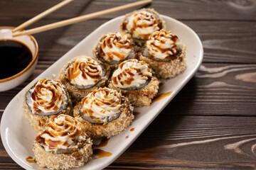 Hot fried Sushi Roll with salmon, avocado and cream cheese, above view. Sushi menu. Japanese food.