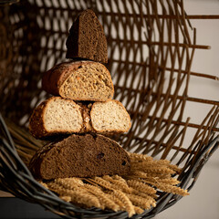 Loaves of bread in cut on ears of wheat in trug. Different types of bread in section. Slide of different types of bread cut form. 