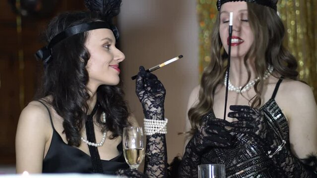 People Dressed In Style Of Roaring Twenties Having Fun On Gatsby Party. Vintage, Retro Party, Fashion, Girls Friends Concept