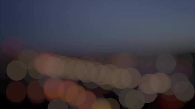 Night building out of focus blinking banger leaks footage. Night city surface blurred lights background loop. Night city skyline blur lens seamless lighting backdrop. 