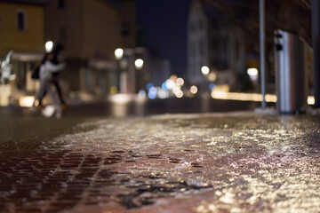 Dangerous ice and icy (Glatteis, Blitzeis) roads in the city. Danger of people slipping on cobblestones. Shot in the early morning, very deep out of focus. Germany, Nurtingen.