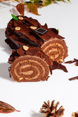 Sliced chocolate cake roll with buttercream and hazelnuts