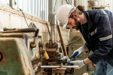 Team of engineers practicing maintenance Taking care and practicing maintenance of old machines in the factory so that they can be used continuously.