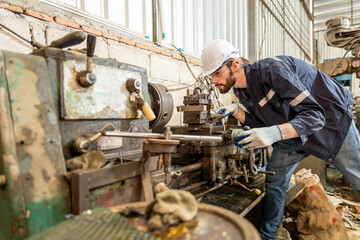 Team of engineers practicing maintenance Taking care and practicing maintenance of old machines in the factory so that they can be used continuously.