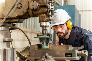Team of engineers practicing maintenance Taking care and practicing maintenance of old machines in the factory so that they can be used continuously.