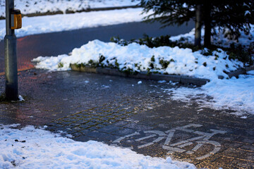Bike path with ice and snow (Glatteis, Blitzeis). Dangerously slippery roads in the early morning. High angle view.