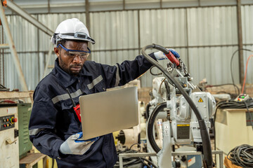 A team of male and female engineers meeting to inspect computer-controlled steel welding robots. Plan for rehearsals and installation for use.