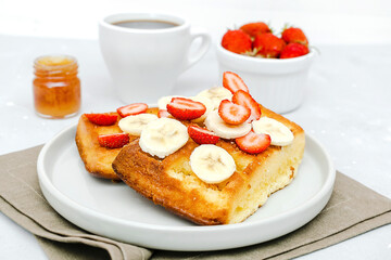 Square belgian waffles with strawberries berries,bananas, cup of coffee.breakfast,sweet dessert food