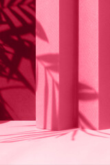Abstract magenta background with shadow of palm leaves for the presentation of a cosmetic product. A scene with a geometric backdrop. Podium for product promotion, beauty, natural eco cosmetic.