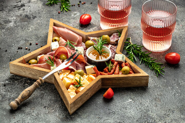 Christmas star board. Mixed cheese and meat with rose wine atipasto, Christmas holidays, place for text, top view