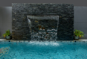 beautiful fake waterfall scene in the swimming pool