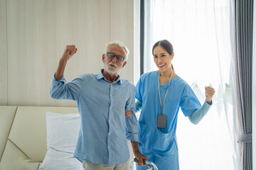 Asian women caregiver take care senior disabled man on wheelchair,Nurse support disabled senior man patient to walk at nursing home