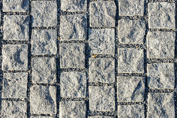 Stone cladding wall made of gray rocks. Decorative stone wall. Beautiful background texture stone lined with granite walls. Vintage texture background, Stone background wall.